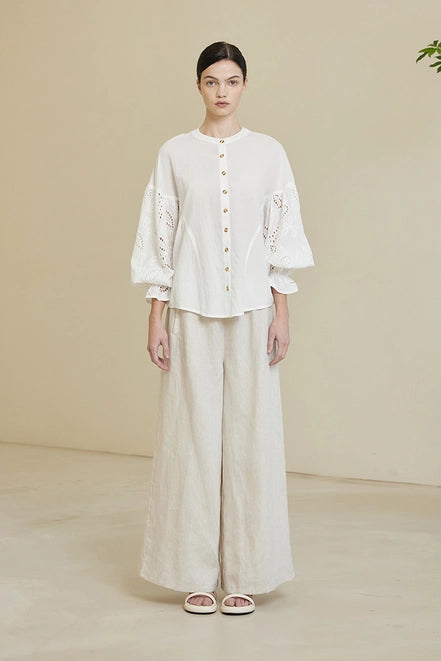 Round neck, button down blouse with embroidered sleeves, on off white.