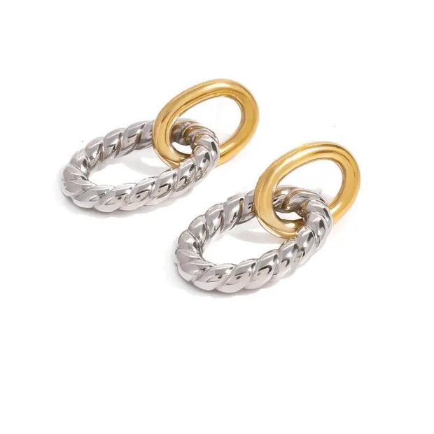 Two pairs of interlocking ring earrings, one silver and one gold, on a white background.