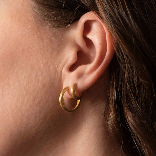 Gold delicate hoop earrings in a brushed finish. Little Nell