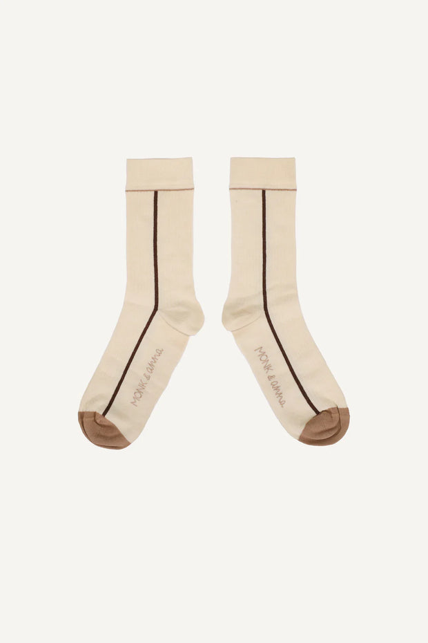 Pair of beige socks with a thin brown line on a white background