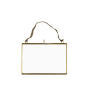 Gold-framed mirror with a strap on a white background