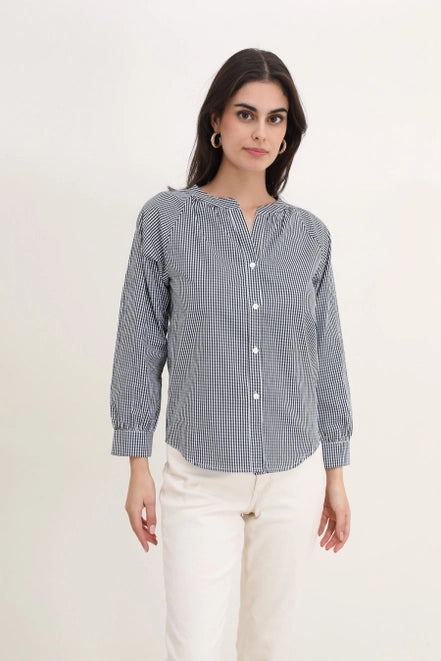 Tristan blouse designed with long sleeves, a V-neck, and a gingham pattern in navy and white. Calie Paris 