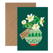 Christmas card with floral design and 'Merry Christmas' tag on a green background