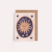 Card with sun and star design on a beige background