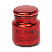 Red candle jar labeled 'Pomme' with a red lid on a white background