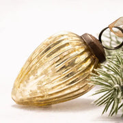 Decorative glass pinecone with ribbed texture on a white background