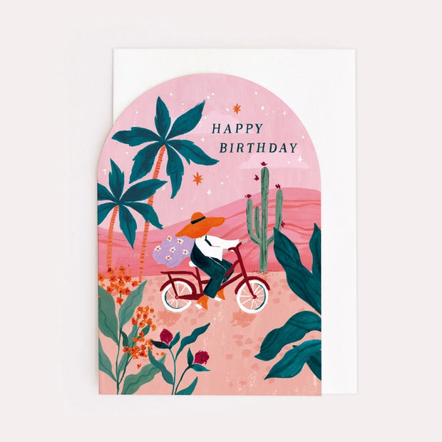 Illustrated birthday card with bike and sunset, perfect for cyclists and adventurers. Stylish arch shape birthday card with a luxury white envelope.