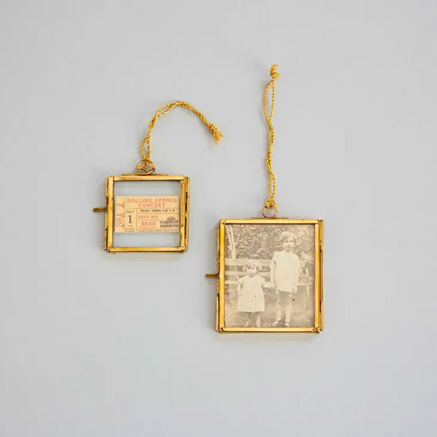 Gold brass and glass square hanging frame. Measuring 8.2 x 7.5 cm 