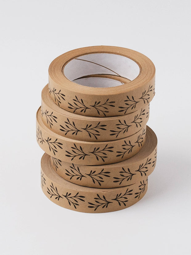 Stack of brown paper tape with leaf pattern on a white background