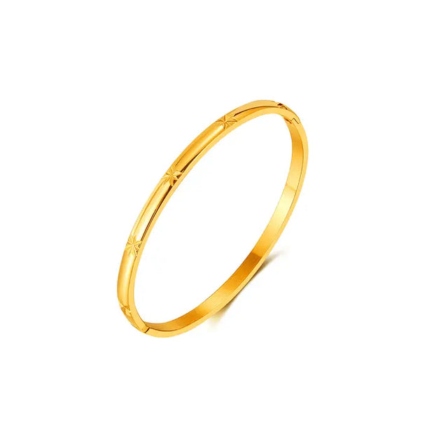 Gold bangle on a white background