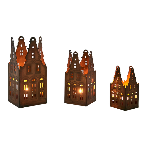 Three decorative lanterns shaped like houses with lit interiors on a white background
