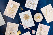 Collection of greeting cards with decorative elements on a dark blue surface