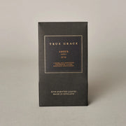 Black box with gold text on a beige background
