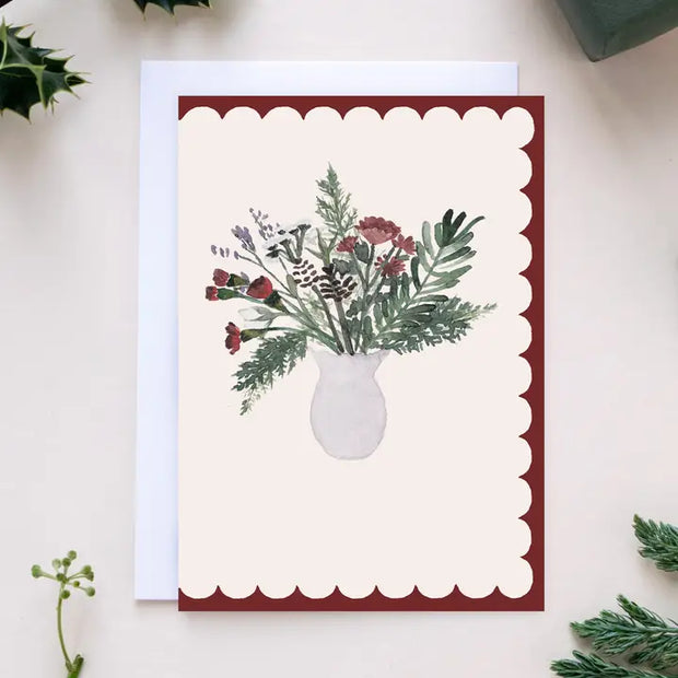 Greeting card with a bouquet of flowers in a vase on a red border