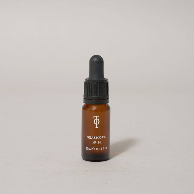 Small brown bottle with dropper on a light gray background