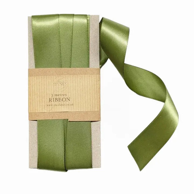 Green ribbon with packaging on a white background