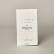 White packaging of 'True Grace' with text on a beige background