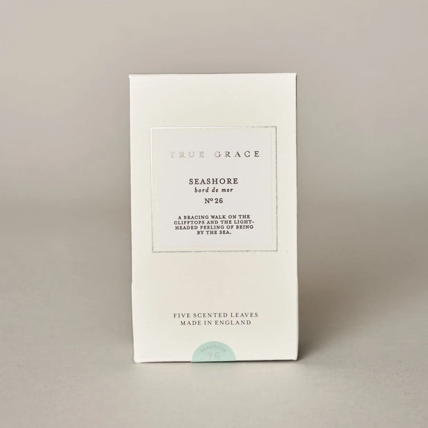 White packaging of 'True Grace' with text on a beige background