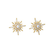 Gold star-shaped earrings with clear gemstones on a white background. Crystal Starburst Earring in Gold White Leaf