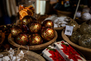 Decorative Christmas ornaments in a wooden basket with a blurred background From Victoria Shop