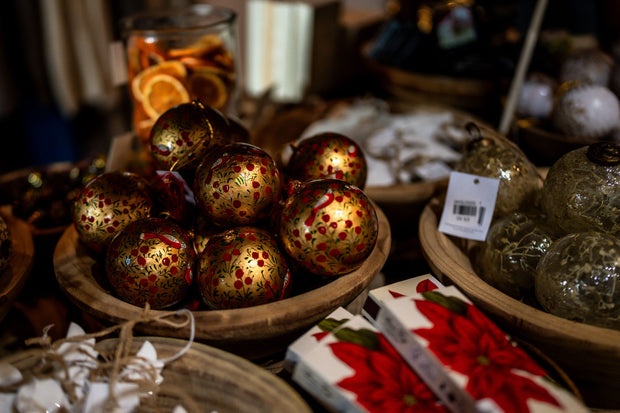 Decorative Christmas ornaments in a wooden basket with a blurred background From Victoria Shop