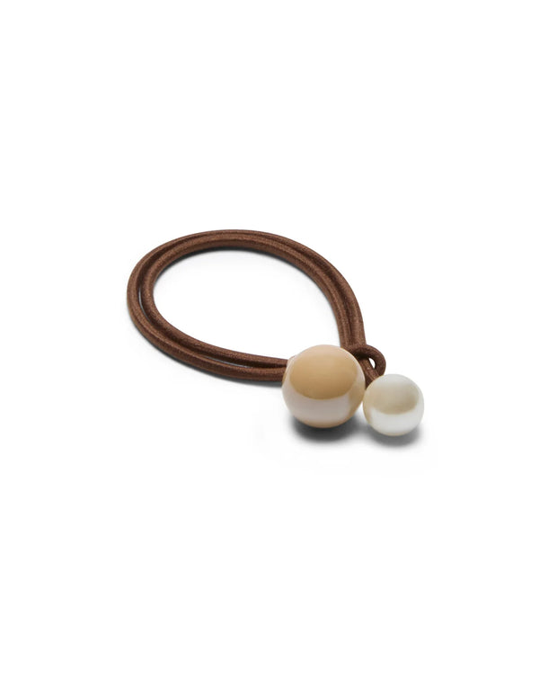 Brown hair tie with two beads on a white background