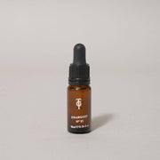 Brown glass dropper bottle with black cap on a light gray background