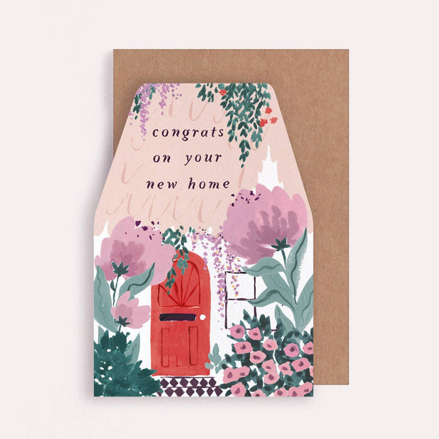 Greeting card with floral design and text 'congrats on your new home' on a brown envelope.