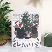 Card with illustration of people around a Christmas tree, text 'Christmas is where your people are', and decorative elements.