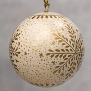Decorative ball ornament with gold patterns on a gray background