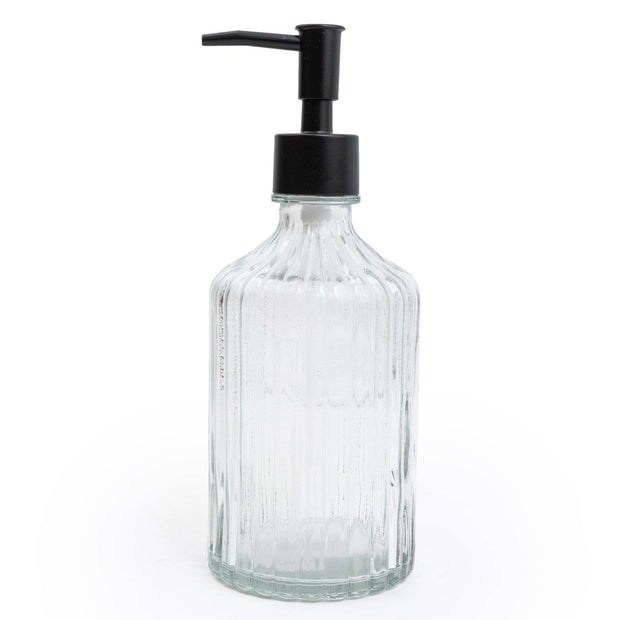 Clear glass bottle with black pump dispenser on a white background
