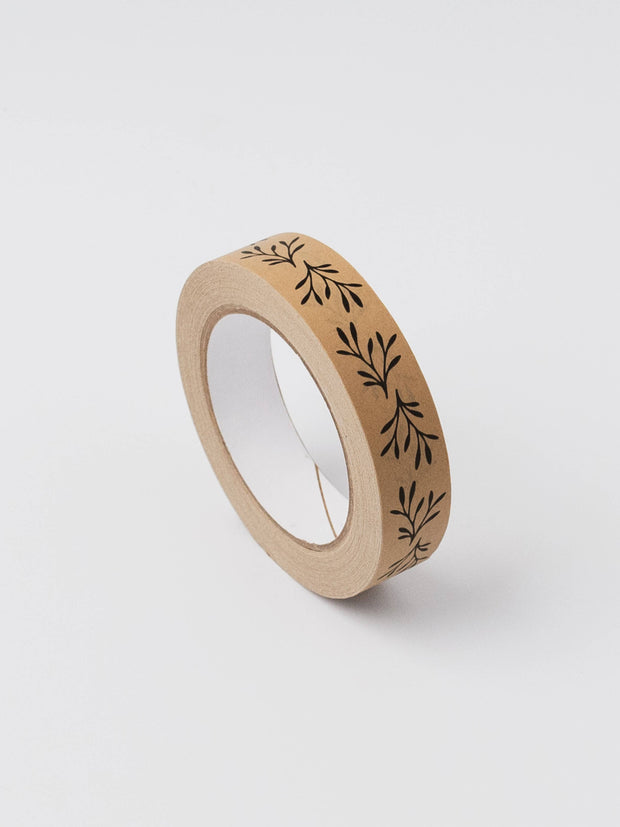 Roll of brown tape with black leaf pattern on a white background