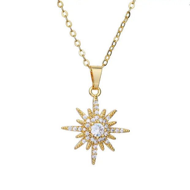Gold necklace with a star-shaped pendant on a white background