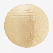 Round paper lampshade in sand