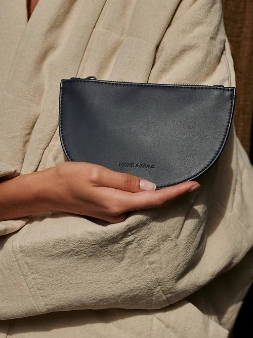 a model showing vegan blue half moon wallet