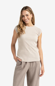 Woman wearing a beige top and pants on a white background, Beige mixed fabric T-shirt with plain sleeves. YAYA