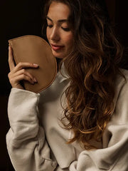 a model holding half moon shaped wallet