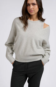 Soft grey sweater with a matching top, both made from soft materials. The sweater has a relaxed fit with a V-neck, while the top features a round neck and wide straps