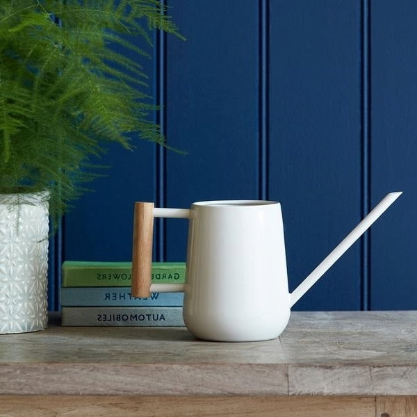 Styled shot of white watering can from Victoria Shop