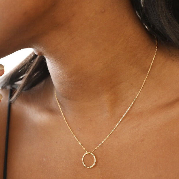 model wearing  Hammered Halo Pendant Necklace in Gold