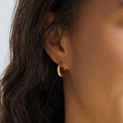 model wearing 18K Gold Stainless Steel Half Moon Hoop Earrings